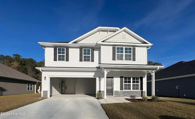 722 Greenwich Pl, Richlands, NC 28574 - view of front facade featuring an attached garage, driveway, stone siding, board and batten siding, and a front yard