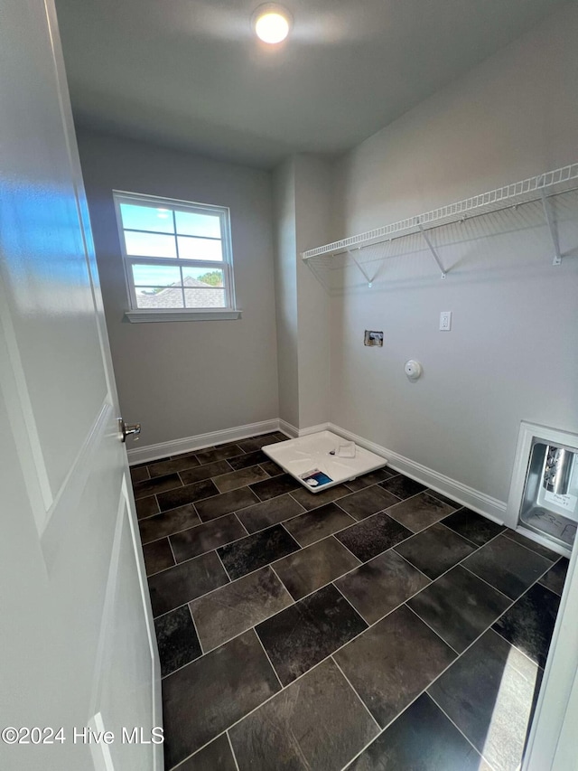 clothes washing area with gas dryer hookup, laundry area, and baseboards