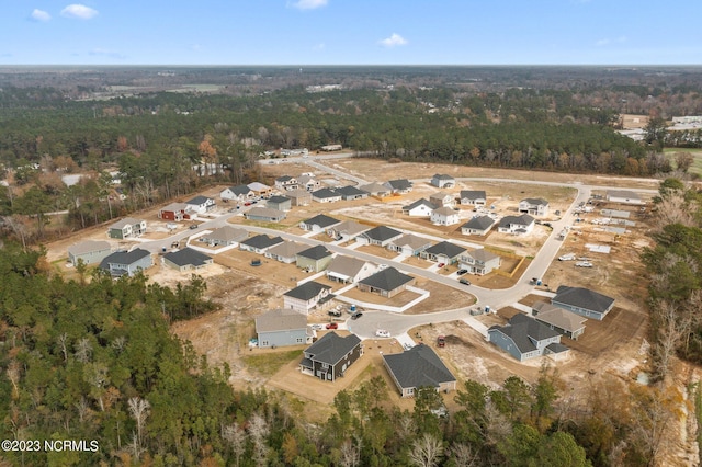 bird's eye view featuring a residential view and a forest view