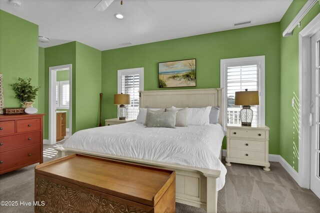 bedroom with multiple windows, baseboards, visible vents, and carpet floors