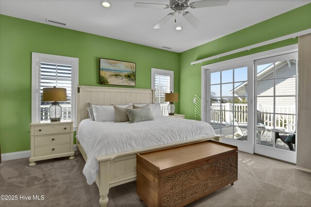 carpeted bedroom with recessed lighting, visible vents, baseboards, and access to exterior