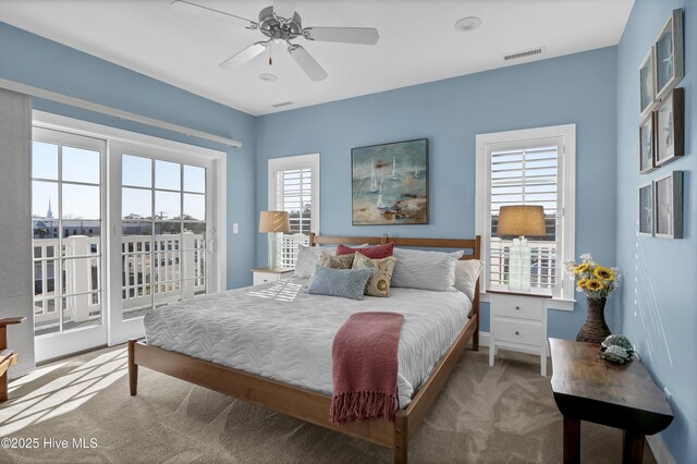 carpeted bedroom featuring ceiling fan, visible vents, and access to exterior