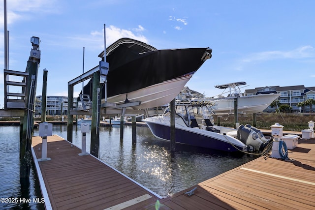 view of dock with boat lift and a water view