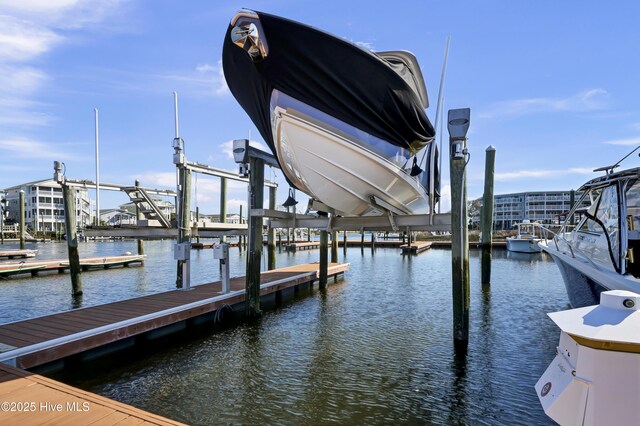 view of dock with boat lift and a water view