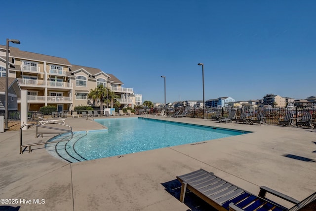 pool featuring a patio and fence