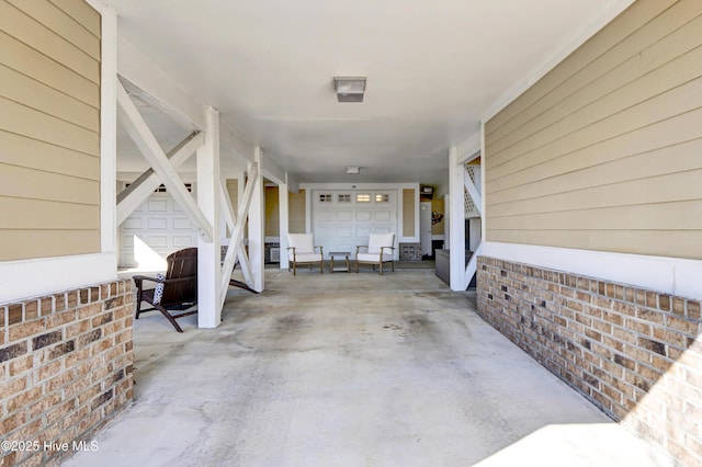 view of patio with a garage and driveway