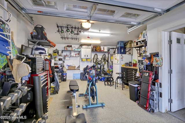 garage with a workshop area and freestanding refrigerator