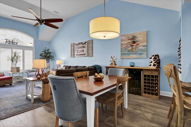 dining space featuring wood finished floors, beverage cooler, visible vents, high vaulted ceiling, and ceiling fan