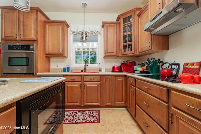 kitchen with oven, glass insert cabinets, black microwave, under cabinet range hood, and brown cabinets