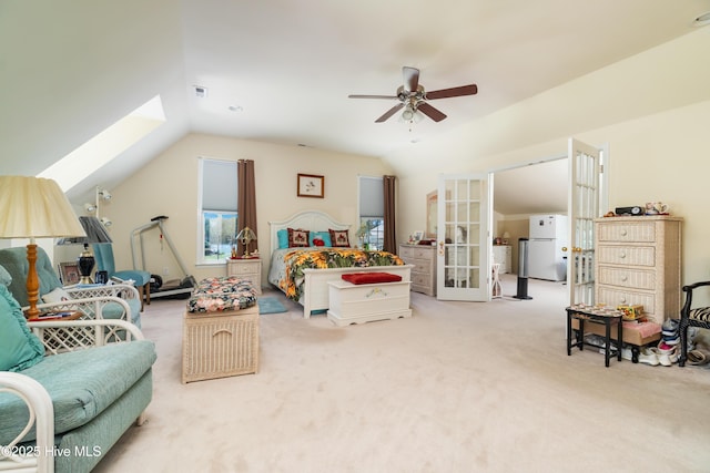 bedroom with carpet, visible vents, lofted ceiling, freestanding refrigerator, and french doors