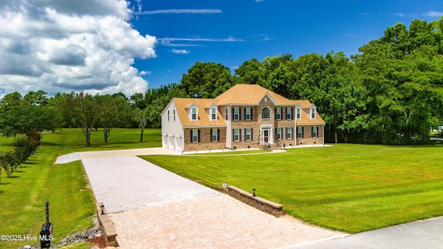 view of front of home with decorative driveway, an attached garage, a front yard, crawl space, and brick siding