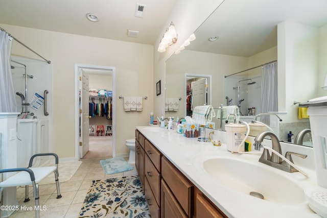 full bath featuring tile patterned floors, a shower with curtain, visible vents, and a sink