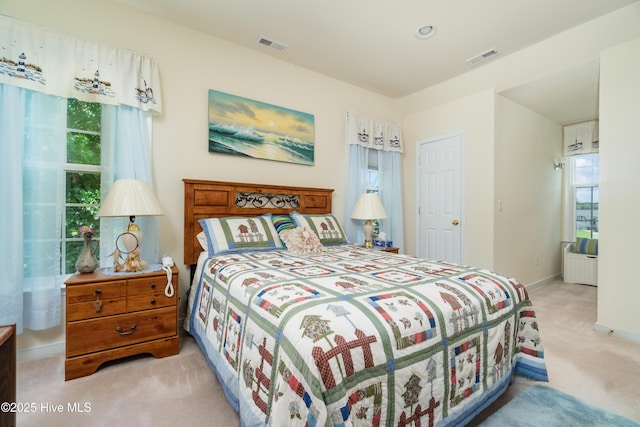 bedroom featuring visible vents, carpet flooring, and baseboards