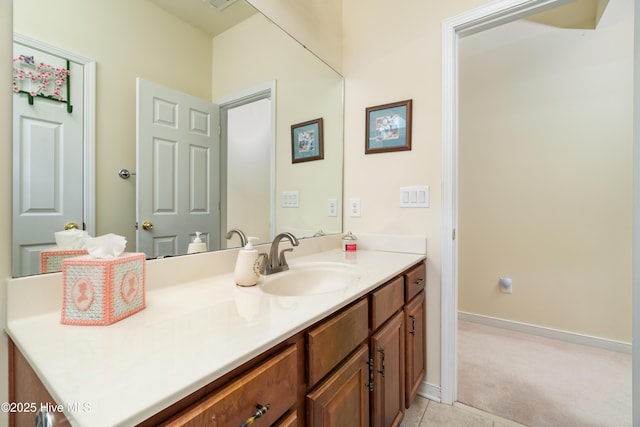 bathroom featuring tile patterned floors, baseboards, and vanity