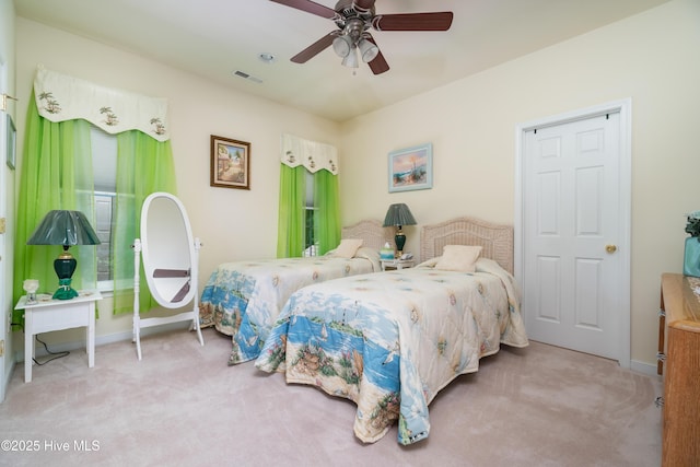 carpeted bedroom featuring visible vents, baseboards, and a ceiling fan