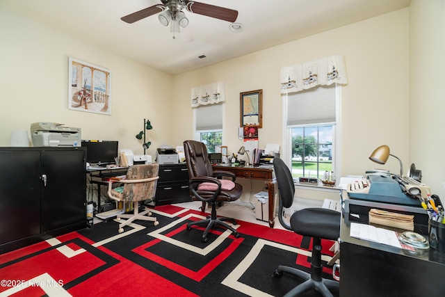 office space featuring a ceiling fan and visible vents