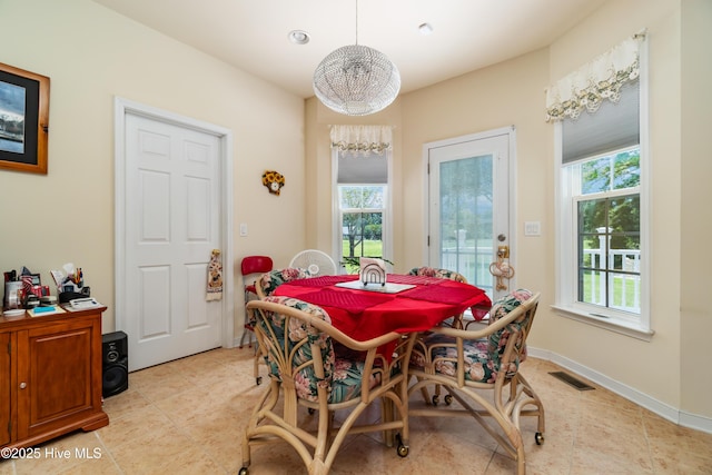 dining area with plenty of natural light, baseboards, and visible vents