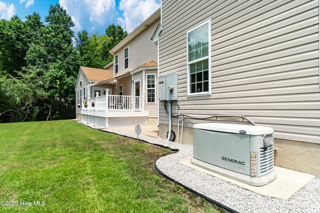 rear view of house featuring a wooden deck and a lawn