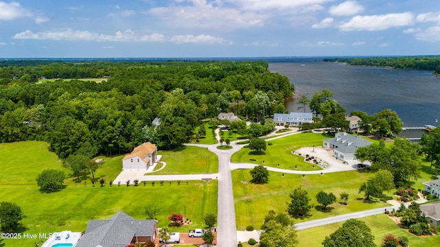 aerial view with a wooded view and a water view