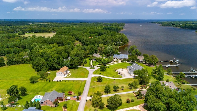 drone / aerial view featuring a view of trees and a water view