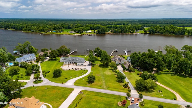 birds eye view of property featuring a wooded view and a water view