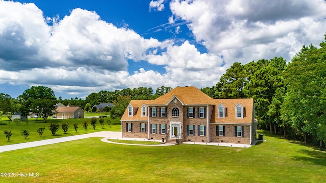 view of front of home featuring crawl space, brick siding, and a front yard