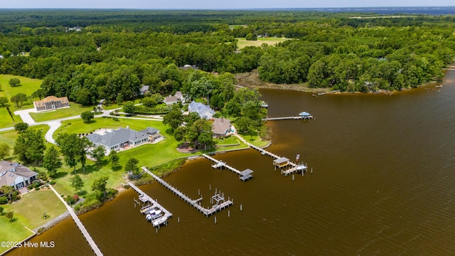 aerial view featuring a wooded view and a water view