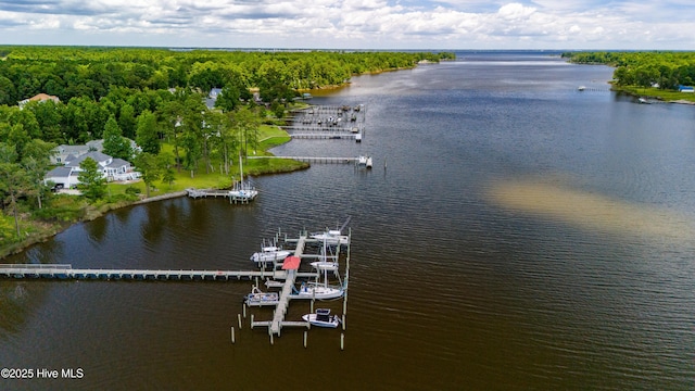 aerial view with a wooded view and a water view