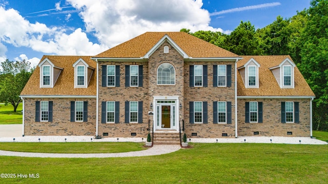 view of front facade featuring crawl space, brick siding, roof with shingles, and a front lawn