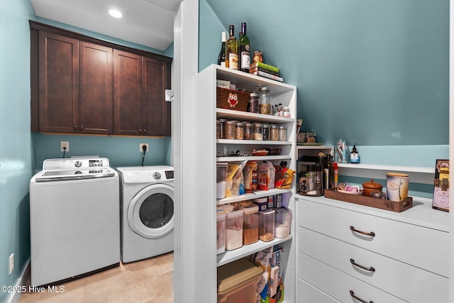 washroom featuring cabinet space, washing machine and dryer, and recessed lighting