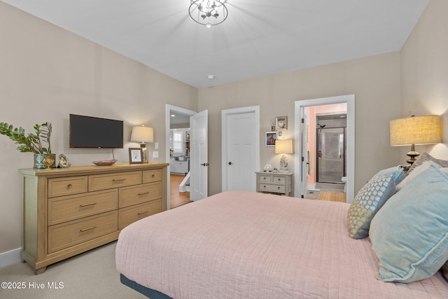 bedroom featuring light carpet, ensuite bath, and baseboards