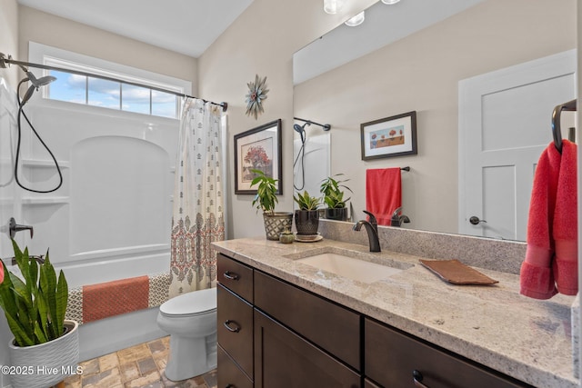 bathroom with toilet, stone finish flooring, vanity, and shower / tub combo with curtain