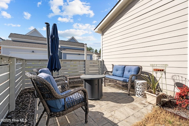 view of patio / terrace featuring fence and an outdoor living space