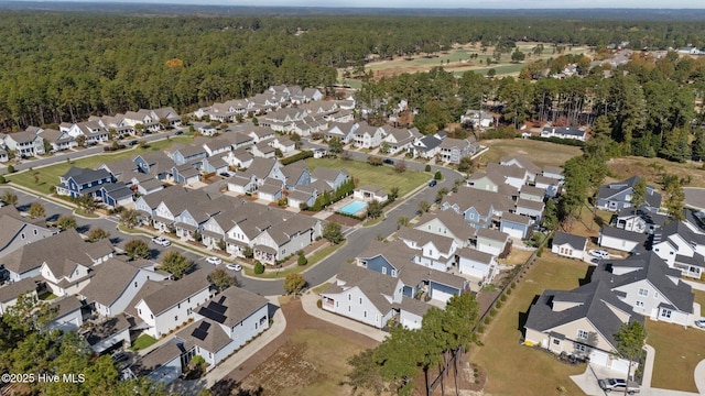 aerial view featuring a wooded view and a residential view