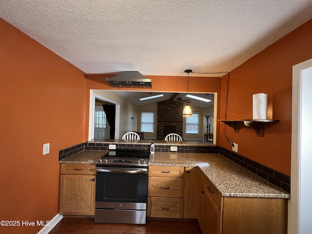 kitchen with pendant lighting, vaulted ceiling, stainless steel electric range, a fireplace, and a peninsula