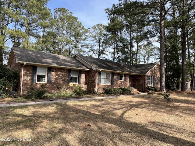 single story home featuring brick siding