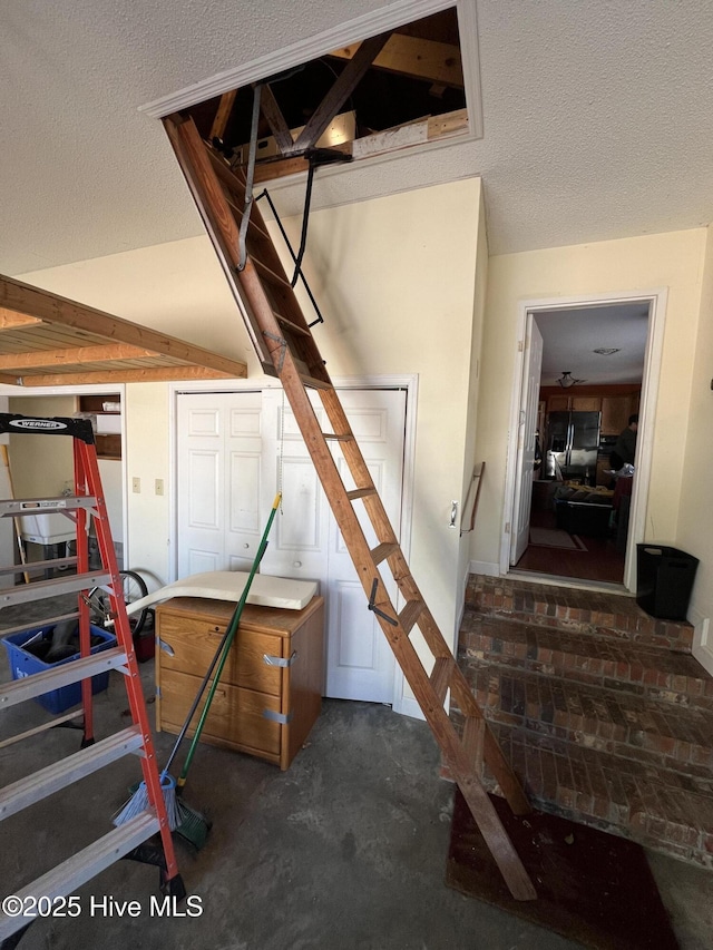 stairs with a textured ceiling