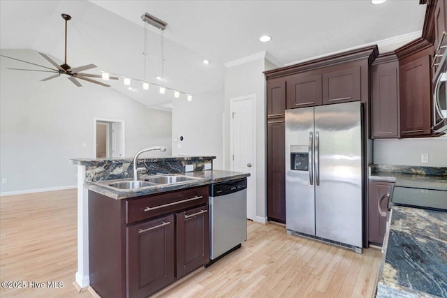 kitchen with appliances with stainless steel finishes, ornamental molding, decorative light fixtures, light wood-style floors, and a sink