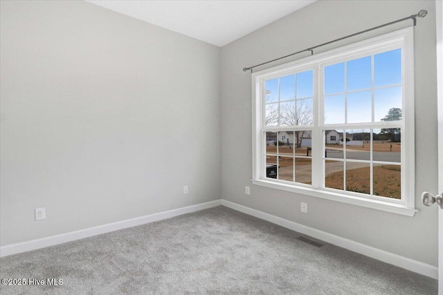 spare room featuring visible vents, baseboards, and carpet flooring