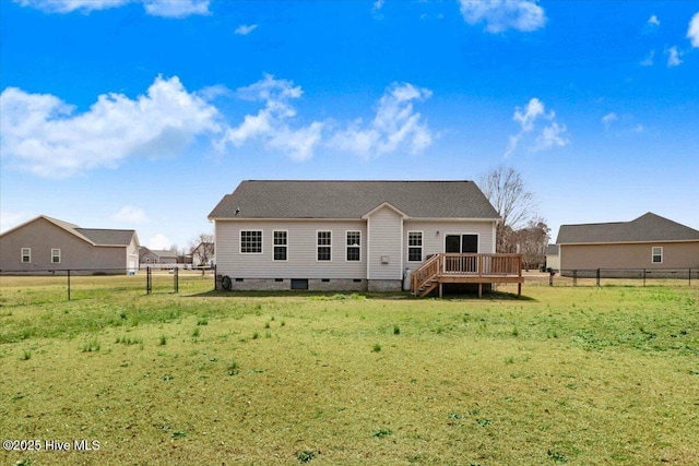 back of property with crawl space, a fenced backyard, a yard, and a deck