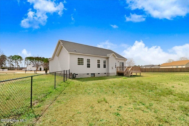 back of property featuring crawl space, a fenced backyard, a lawn, and a wooden deck