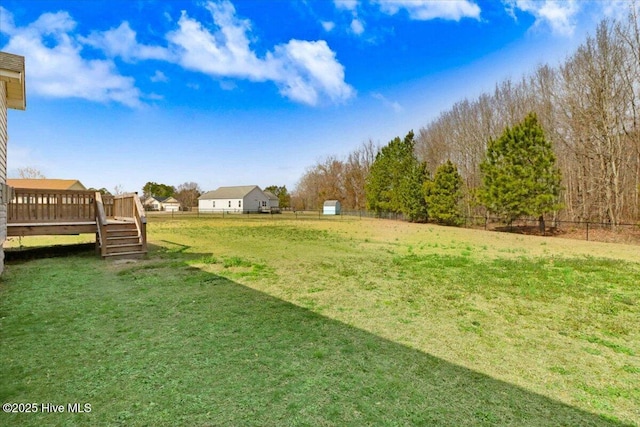 view of yard with fence and a wooden deck