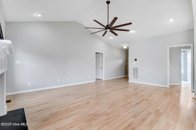 unfurnished living room with ceiling fan, a fireplace, visible vents, baseboards, and light wood finished floors