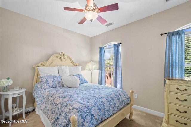 bedroom featuring carpet, baseboards, visible vents, and ceiling fan