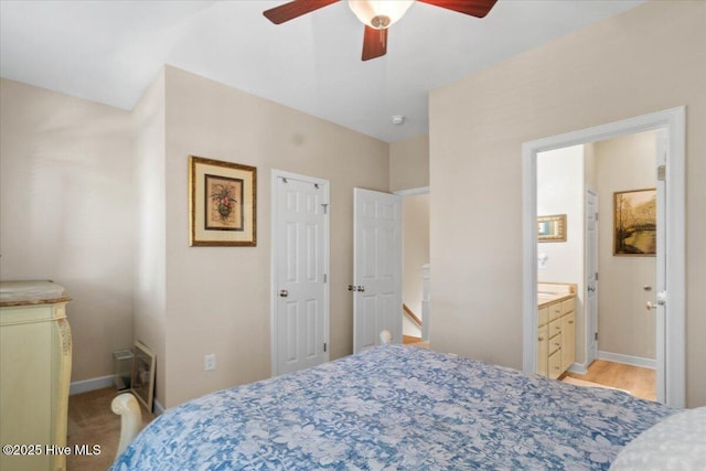 bedroom with connected bathroom, a ceiling fan, and baseboards