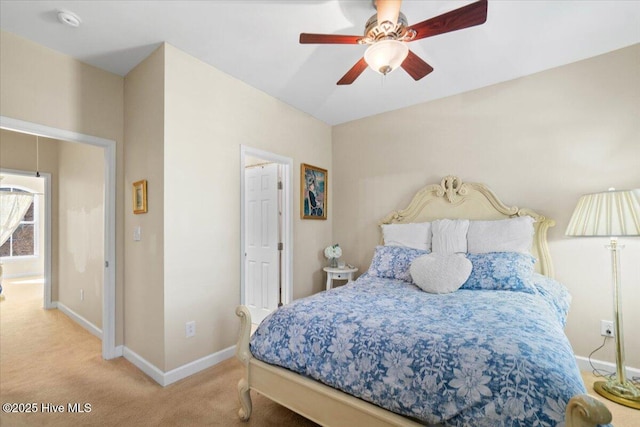 carpeted bedroom with ceiling fan and baseboards