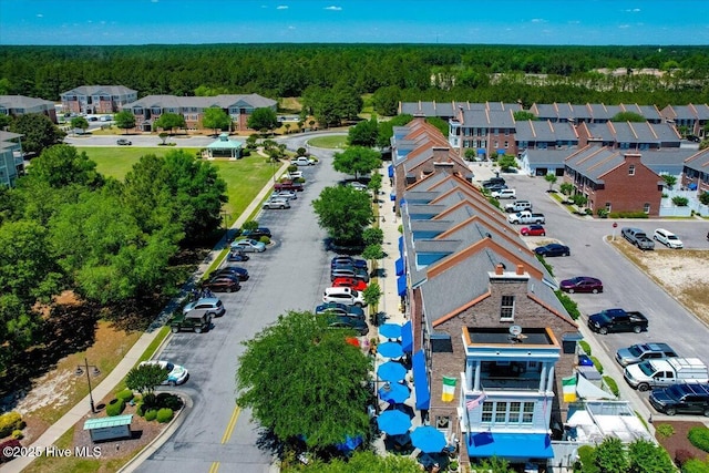 birds eye view of property featuring a residential view and a view of trees