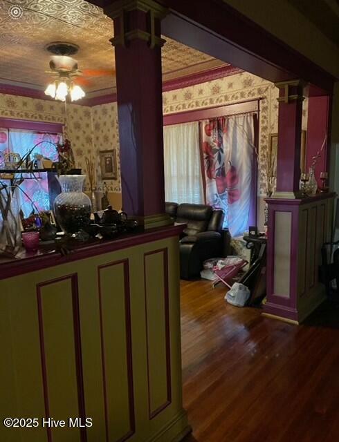 welcome area featuring a ceiling fan and decorative columns