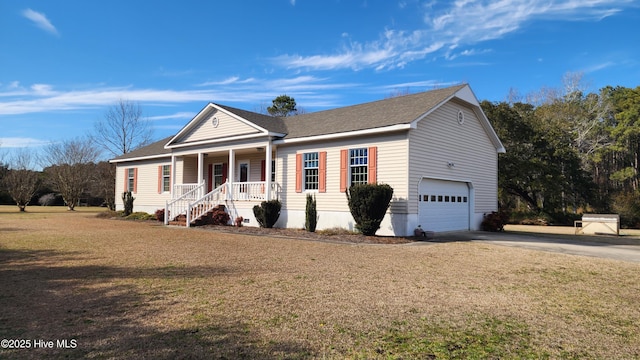 view of front of home featuring covered porch, a garage, concrete driveway, roof with shingles, and a front yard