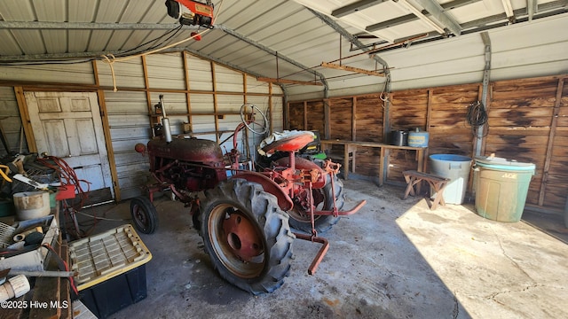 garage featuring metal wall and a garage door opener